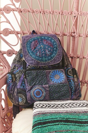 Peace Sign Flap Backpack in decor setting