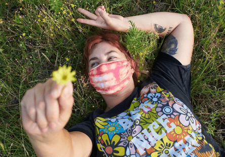 Team member holding daisy towards the sky